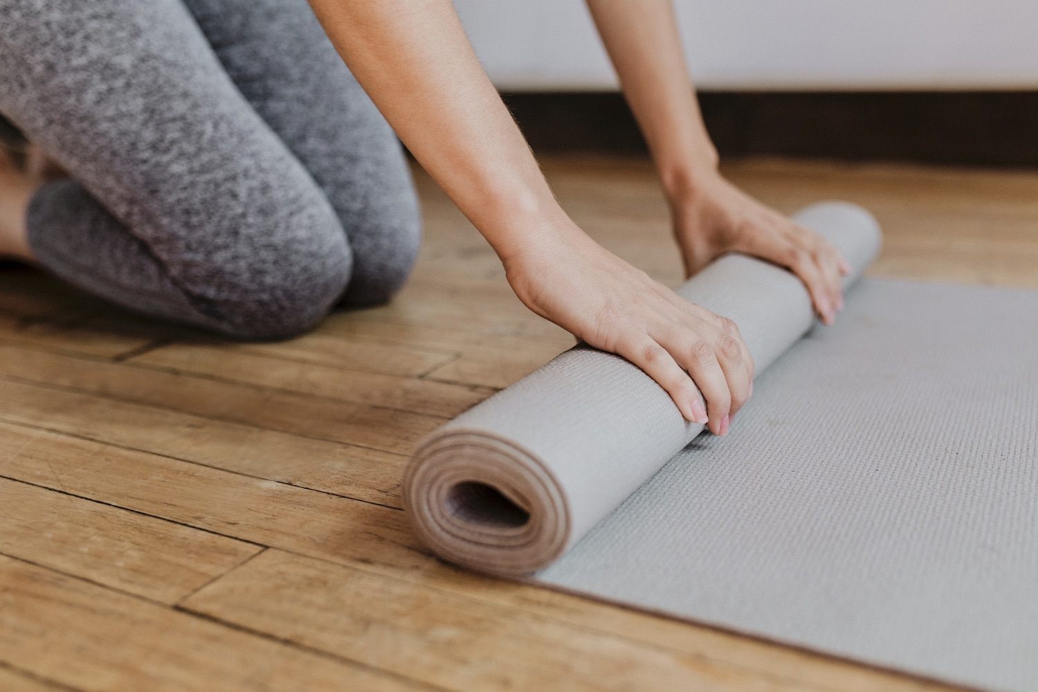 Men and Women Rolling Yoga Mats on the Floor · Free Stock Photo